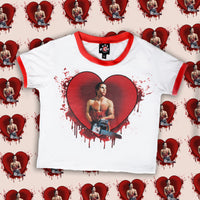 solid white ringer tee with red trim and American Psycho print. Man holding chainsaw in red heart with blood
