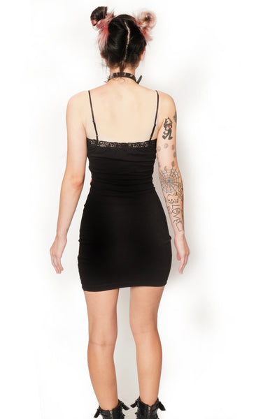 Back view of thin strap mini dress with black lace trim neckline