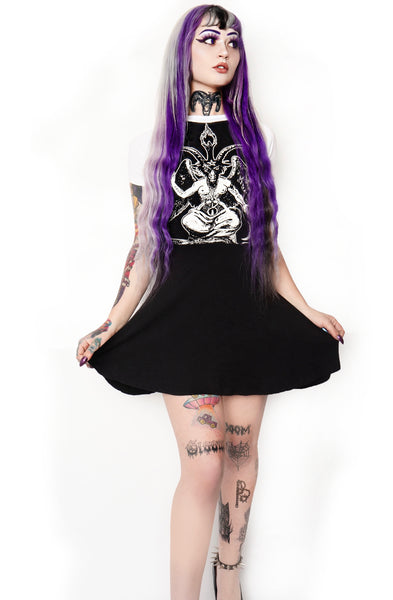 Black baby doll style dress with white baseball tee short sleeves and white trim neckline. White print on dress features Baphomet goat.