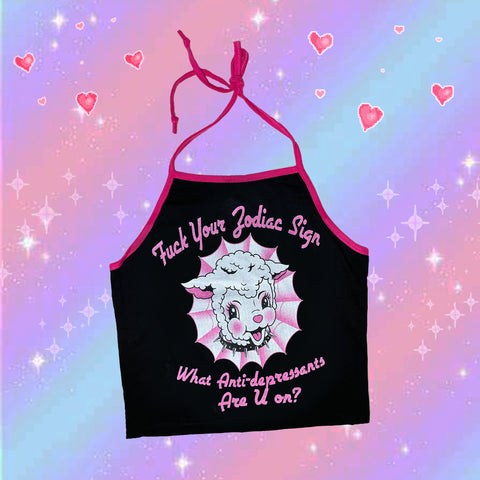 Black halter top with thin pink straps that tie around neck and thin pink trim. Features pink and white lamb wearing a black chocker. Inscription reads "Fuck Your Zodiac Sign" and "What Anti-depressant Are U on?" in pink.