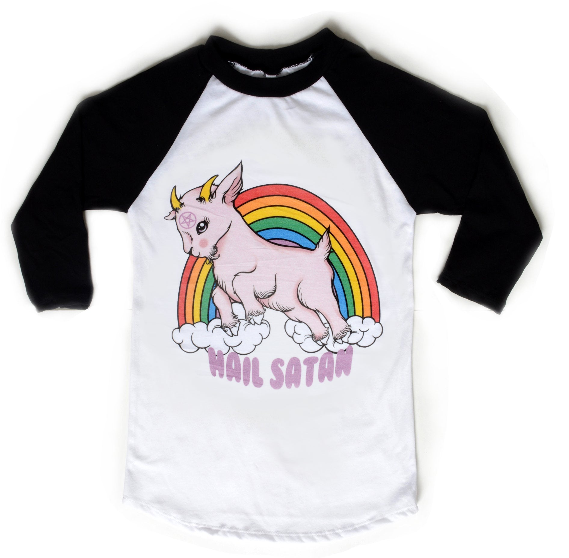White baseball tee with black sleeves and black trim neckline. Features animated pink goat with pentagram on forehead. Clouds and rainbow behind goat. Written underneath goat is "Hail Satan" in pink font.