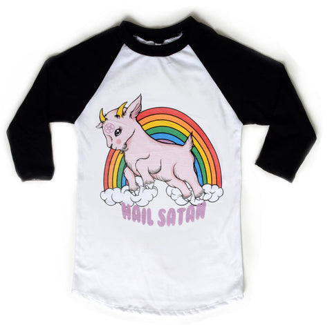 White baseball tee with black sleeves and black trim neckline. Features animated pink goat with pentagram on forehead. Clouds and rainbow behind goat. Written underneath goat is "Hail Satan" in pink font.