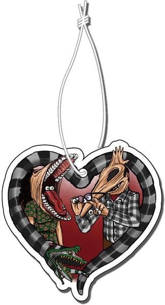 Air freshener with white elastic band. Features image of Barbara and Adam from the movie Beetlejuice. Barbara has face stretched with mouth open, tongue sticking out and eyes in mouth. Adam has his face stretched out with eyeballs on his fingers and glasses in hand. Black and white Beetlejuice snake around Adam and Barbara in the shape of a heart.