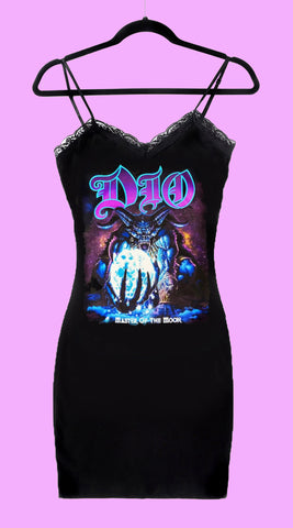 Black dress with thin straps and black lace trim neckline. Print shows blue devil monster holding moon with inscription "Master of the Moon" in white font and "Dio" band name written in purple font