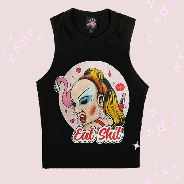 Black high neck sleeveless tank. Features woman with makeup winking her eye. Lipstick, hearts, and flamingo behind her with a pink background. Inscription reads "Eat Shit" written in pink font.