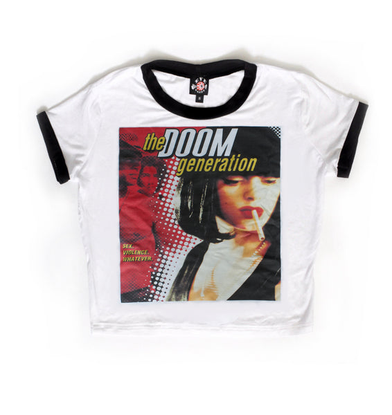 White ringer tee with black trim. Features image of woman with cigarette in mouth and two men one shirtless with cowboy hat. Inscription reads "SEX. VIOLENCE. WHATEVER" in yellow and "the DOOM generation" in yellow and white.