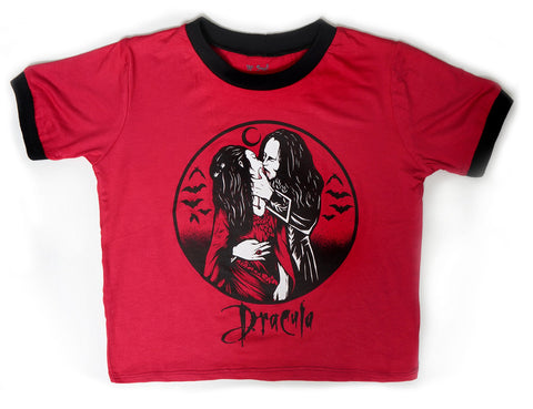 Red ringer tee with black trim. Print features man and woman embracing in a kiss with bats and crescent moon in background. Inscription reads "Dracula" in black font.