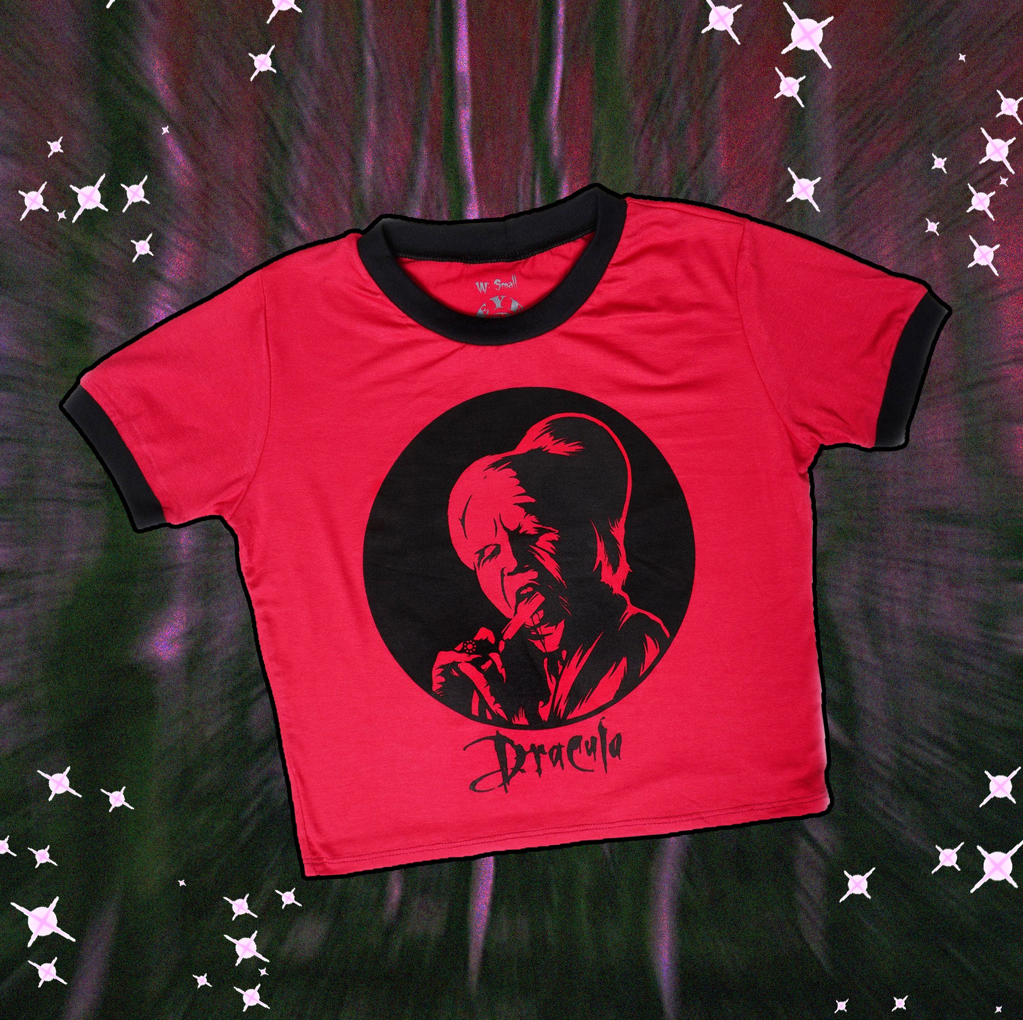 Red ringer tee with black trim. Black print features vampire licking bloody razor. Black font reads "Dracula".