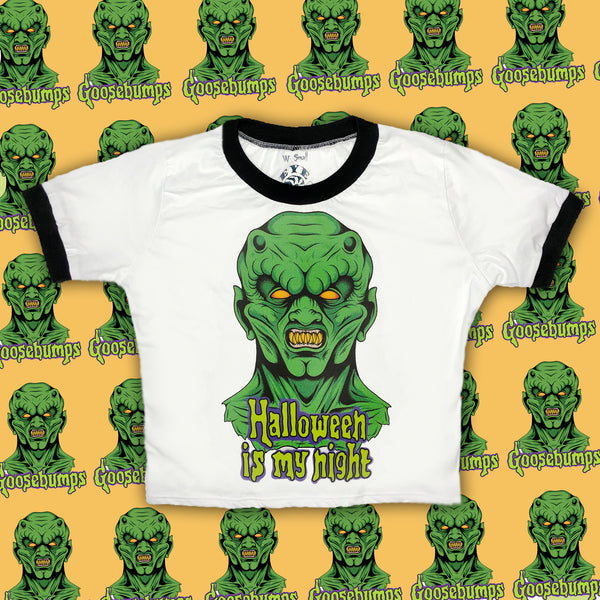 White ringer tee with black trim. Print features green monster with sharp teeth. Inscription reads "Halloween is my night" in green.