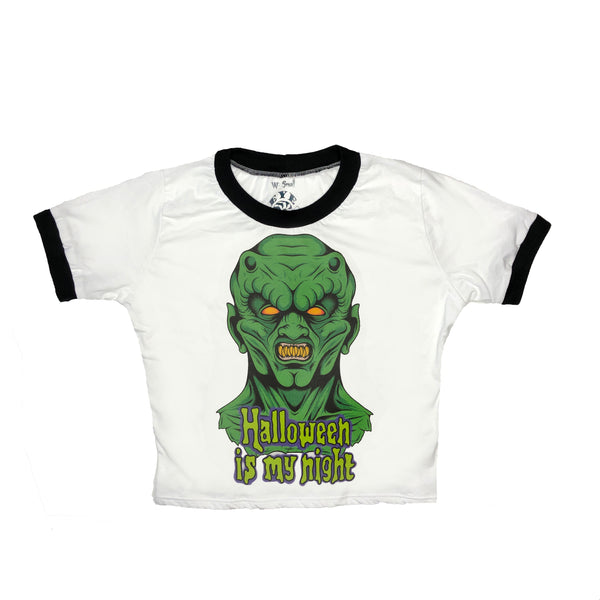 White ringer tee with black trim. Print features green monster with sharp teeth. Inscription reads "Halloween is my night" in green.