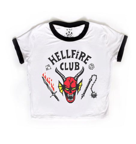 White short sleeve ringer tee with black trim. Features image of devil's head at center with bloody sword and a flail. Inscription reads "HELLFIRE CLUB" in white.