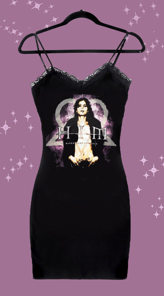 Black thin strap mini dress with black lace trim neckline. Print features Ville Valo with heartagram and pink background. Written in beige font is "HIM"