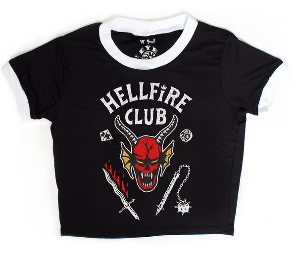 Black short sleeve ringer tee with white trim. Features image of devil's head at center with bloody sword and a flail. Inscription reads "HELLFIRE CLUB" in white.