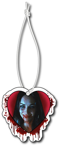 Air freshener with white elastic band. Features image of Jennifer from movie Jennifer's Body, smiling with blood on mouth and neck inside heart shape. Blood splatter around heart and red background.