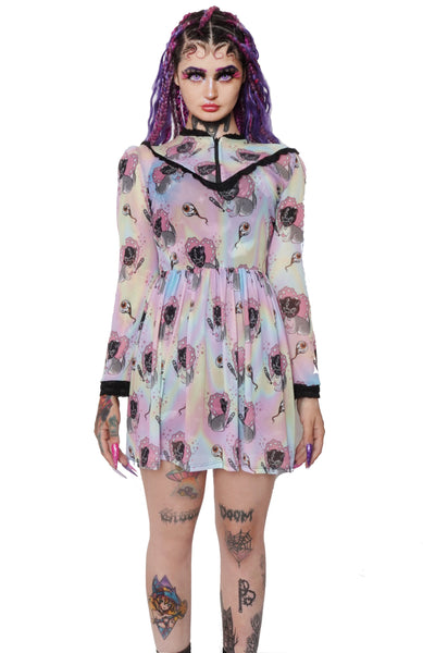 Pastel color Victorian style mesh dress with long sleeves, black lace trim neckline, black lace cuffs and black lace V shape detail from mid chest to shoulders. Zipper located from neckline to V shape trim on chest. Dress is cinched at waist. Print features images of gray cat wearing a black bondage gimp mask holding a paddle. Print also features eyeballs.