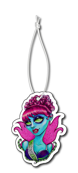 Air freshener features cartoon blue pageant queen with red hair and green eyes wearing sash that reads "MISS ARGENTINA".