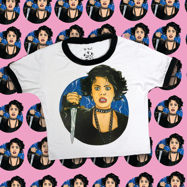 White ringer tee with black trim. Features Nancy from the movie "The Craft" holding a knife and lighting in the background.