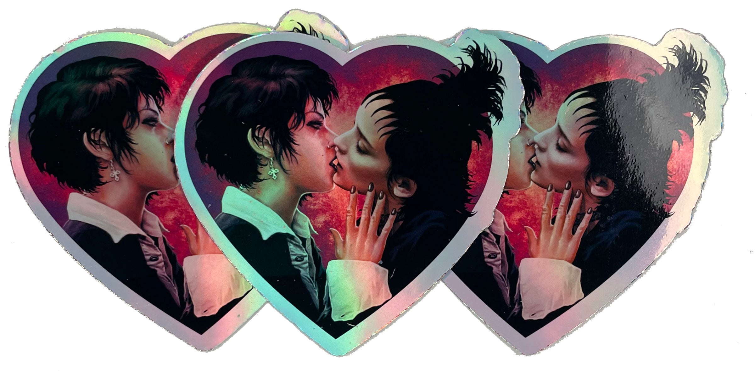 Heart shape holographic vinyl sticker.  Features Nancy from the movie "The Craft" and Lydia from "Beetlejuice" kissing.