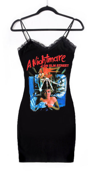 Black thin strap mini dress with black lace neckline. Features image on woman laying in bed under sheets with Freddy Krueger knife hand above her head. Inscription reads "A Nightmare ON ELM STREET" in red.