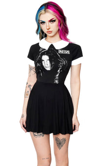 Black baby doll short sleeve dress with white collar and white cuffs. White print features man with black gloves holding his face. Inscription reads "NIN" in white.