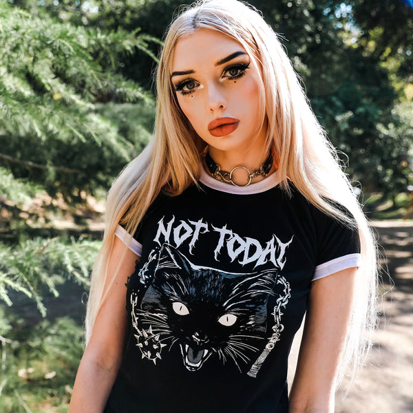 Black ringer tee with white trim. Features image of a black cat and a morning star weapon. Inscription in white reads "NOT TODAY".