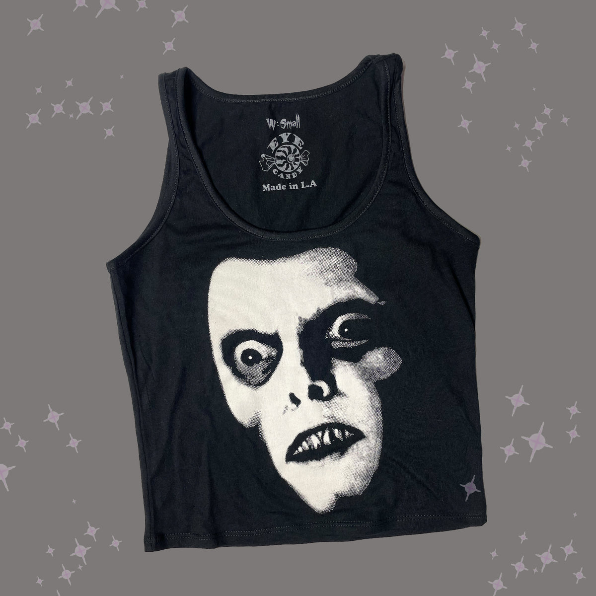 Black tank top. Features white print face of Pazuzu.