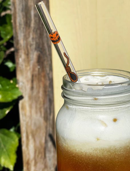 Glass clear straw. Features orange and black image of jack o lanterns and noose.