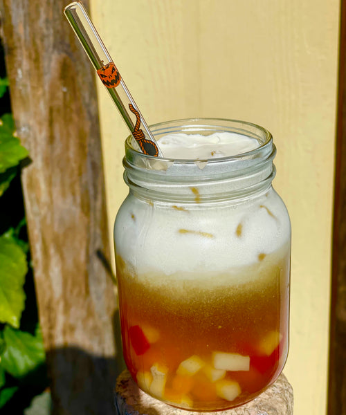 Glass clear straw. Features orange and black image of jack o lanterns and noose.