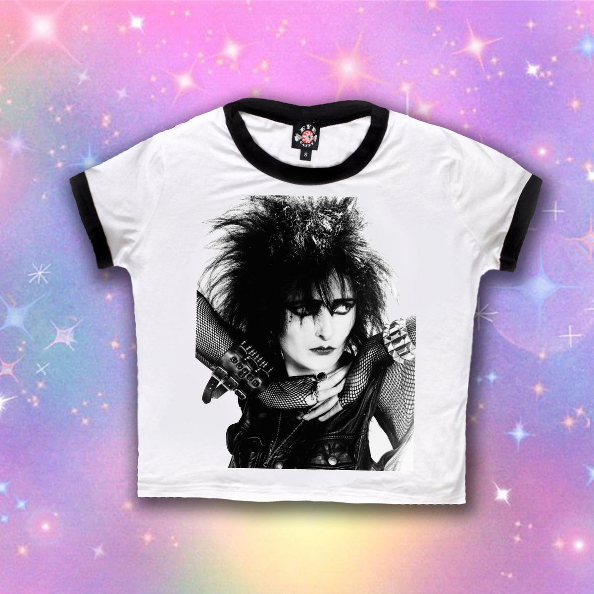 White ringer tee with black trim. Features black and white of Siouxsie Sioux with black eye makeup wearing fishnet long sleeves.