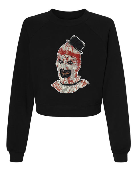 Black pull over long sleeve sweater. Features clown from the movie Terrifier wearing a black top hat with red blood splattered on face.
