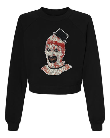 Black pull over long sleeve sweater. Features clown from the movie Terrifier wearing a black top hat with red blood splattered on face.