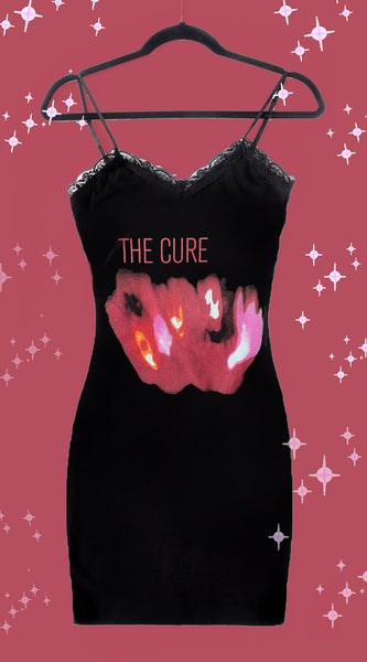 Black thin strap mini dress with black lace trim neckline. Features red blurred image of band members from The Cure. Inscription reads "THE CURE" in red.
