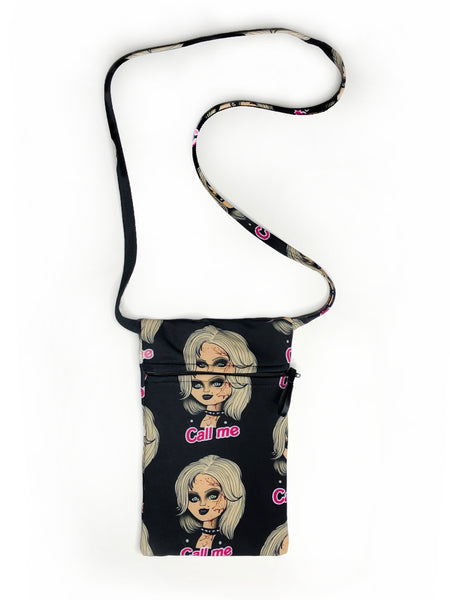 Black small rectangle long thin strap cross over purse with zipper in front. Features Tiffany from the movie Bride of Chucky wearing black jacket and black choker necklace with blood splattered on her. Pink inscription reads "Call me".