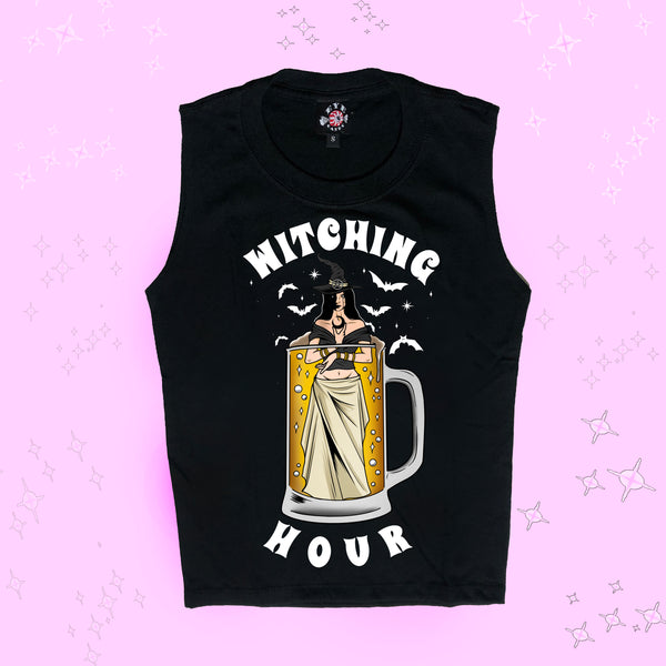 Black high neck sleeveless tank top. Features witch wearing black and white inside a mug filled with beer. White bats in background. Inscription reads "WITCHING HOUR" in white.